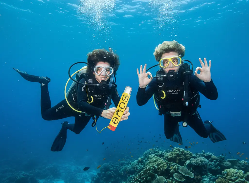 Two divers underwater with ENOS tracking device